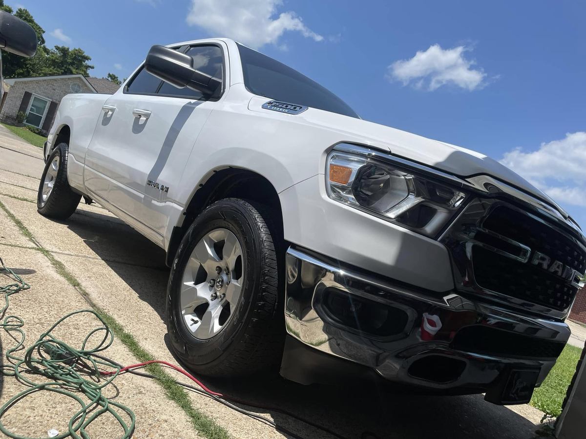 White Ram 1500 front end in a driveway after a detail, grille and chrome clean