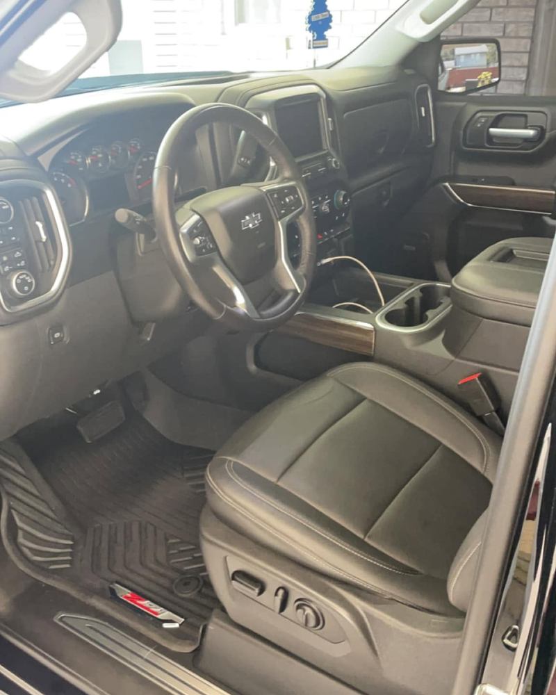 Brown leather front seats and dash of a Chevy Silverado after an interior detail